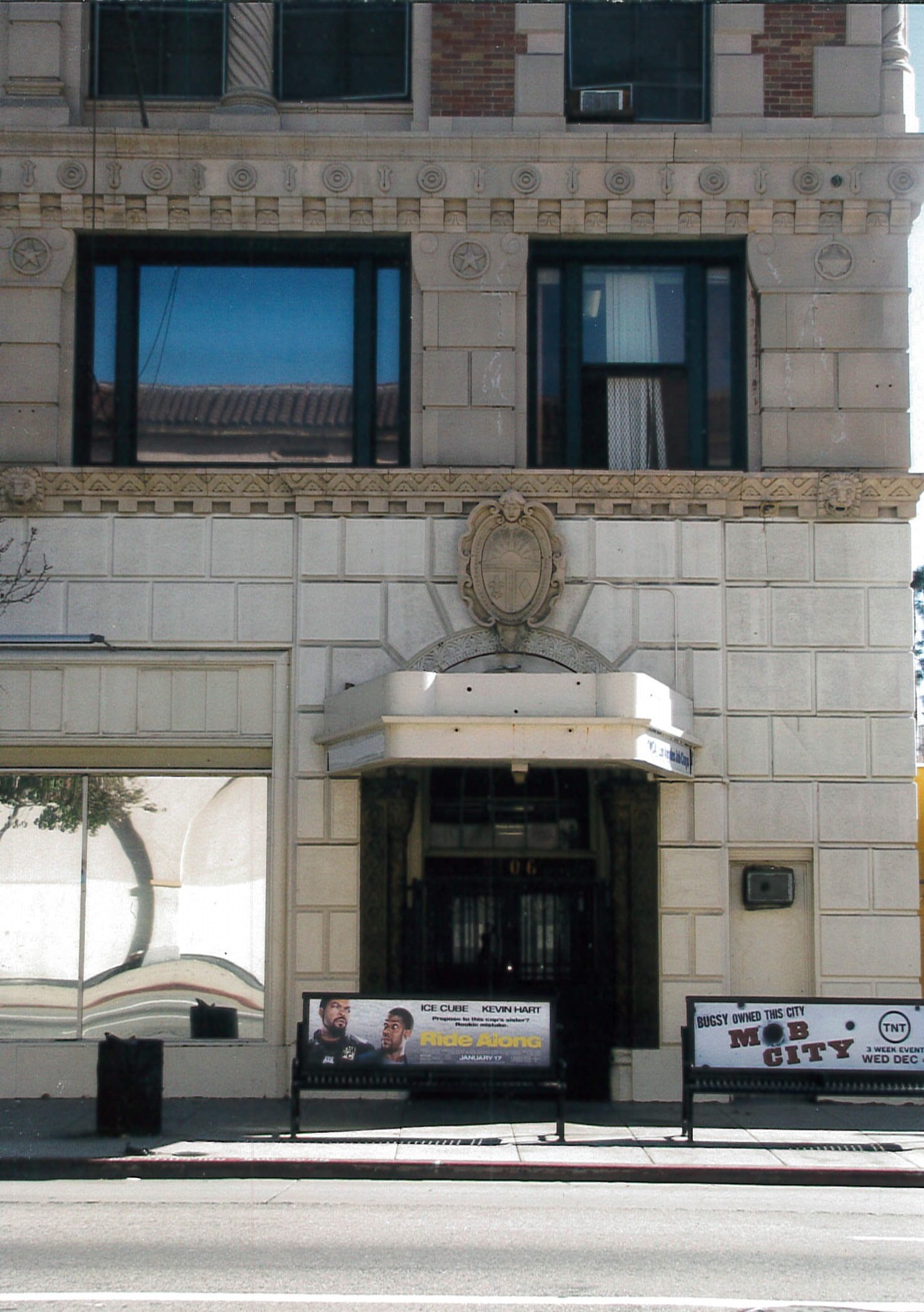Entrance with non-original canopy obscuring original archway